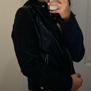 Leather jacket with sweater sleeves and hood